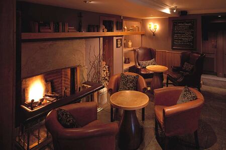 By the fire in the Gumstool Inn at calcot manor england uk