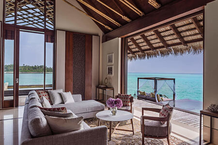 grand water villa living room at reethi rah resort maldives