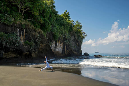 Yoga on the beach at amankila hotel bali