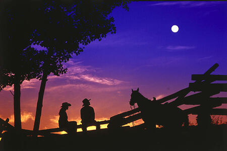 cowboys at sunset at echo valley ranch canada at echo valley ranch canada