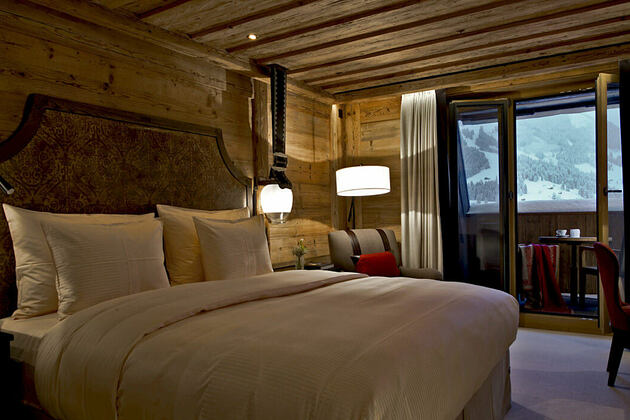 deluxe bedroom at alpina gstaad hotel switzerland