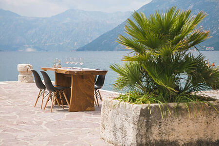 dining on the waterside pontoon at palazzo radomiri hotel montenegro