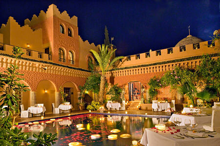 dinner by the pool at kasbah tamadot hotel morocco