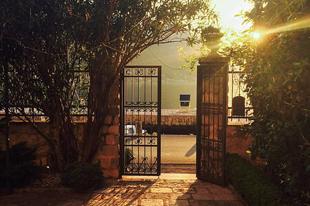 garden gates leading out to boka kotorska bay at palazzo radomiri hotel montenegro