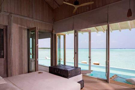 overwater villa bedroom view at soneva jani beach resort