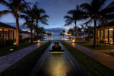 walkway to swimming pool and beach beyond at fusion maia resort vietnam