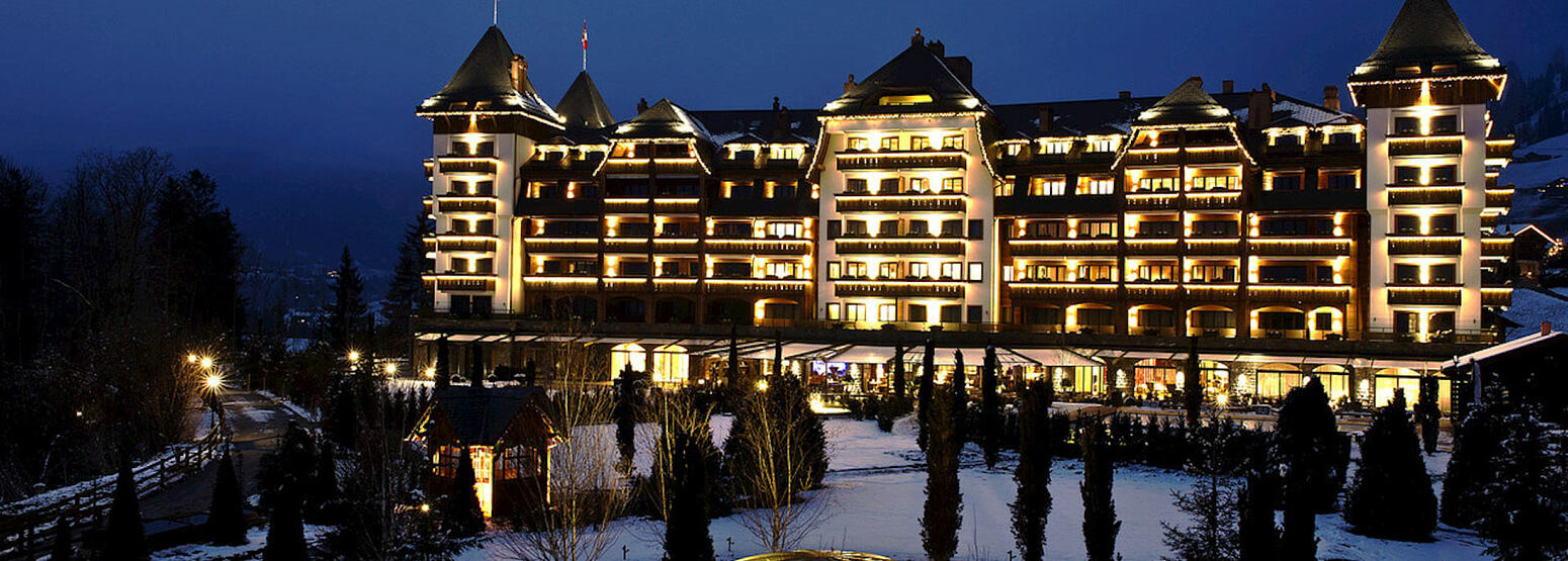 winter exterior view at night at alpina gstaad hotel switzerland