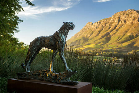 Cheetah sculpture against a panoramic backdrop at Delaire Graff South Africa
