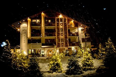 ront view during snowfall of Hotel La Majun Italy