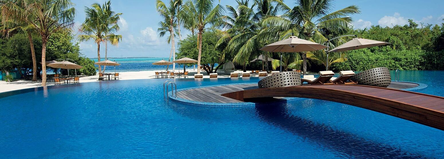 Main Pool with beach and sea background at Hideaway Beach Resort Maldives