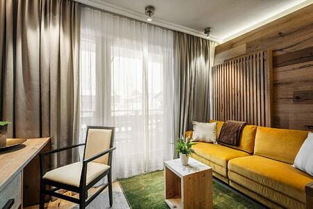Living area of bedroom suite at Hotel La Majun Italy