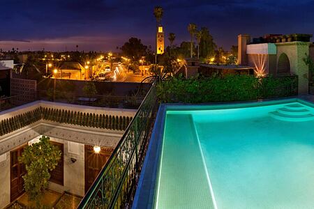 View of the Pool terrace and city at night at Villa des Oranges Morocco