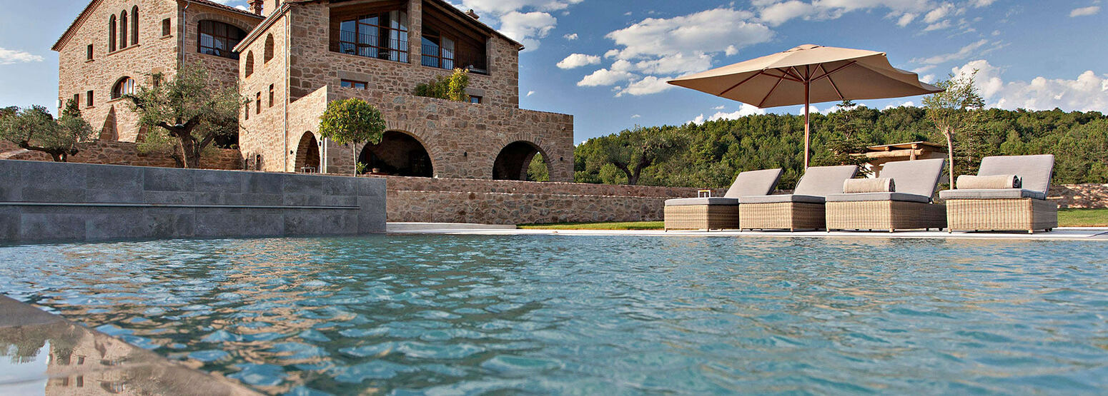 A view across the pool towards la Vella Farga Spain