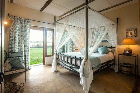 Bedroom with view of river at Tangala House Zambia