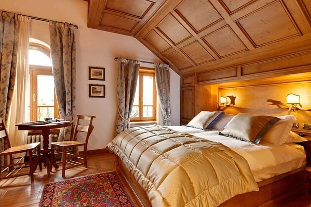 Gold bedspread Bedroom at Hotel Ambra Italy
