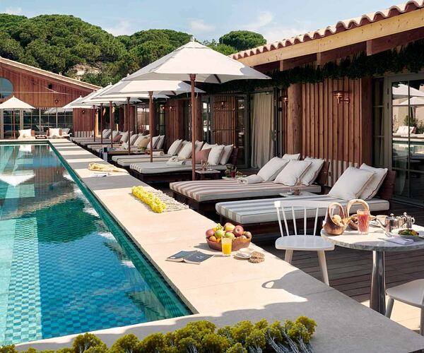 Swimming pool with beds and chairs at Lily of the Valley France