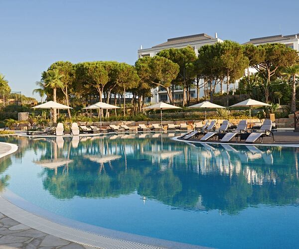 exterior view of the conrad algarve featuring pool and sun loungers