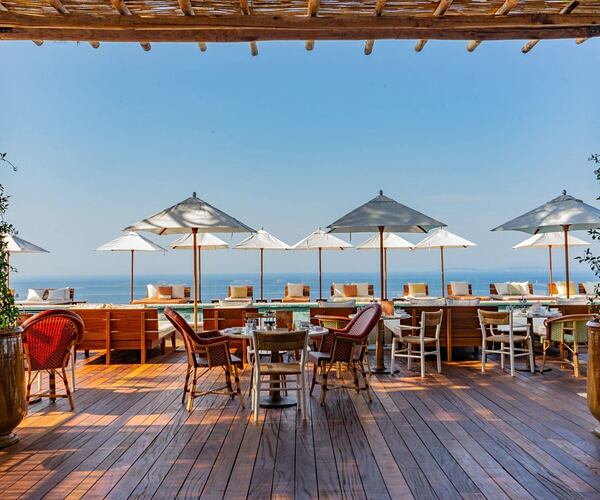 Outdoor dining area with sea view at lily of the valley cote dazur