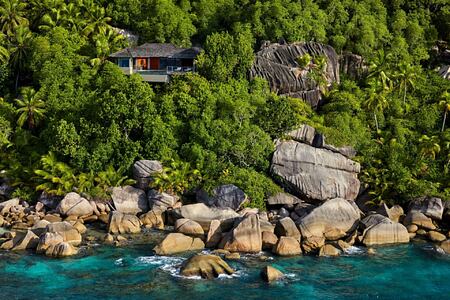 Aerial view of two villas nestled into the rock at six senses zil pasyon seychelles