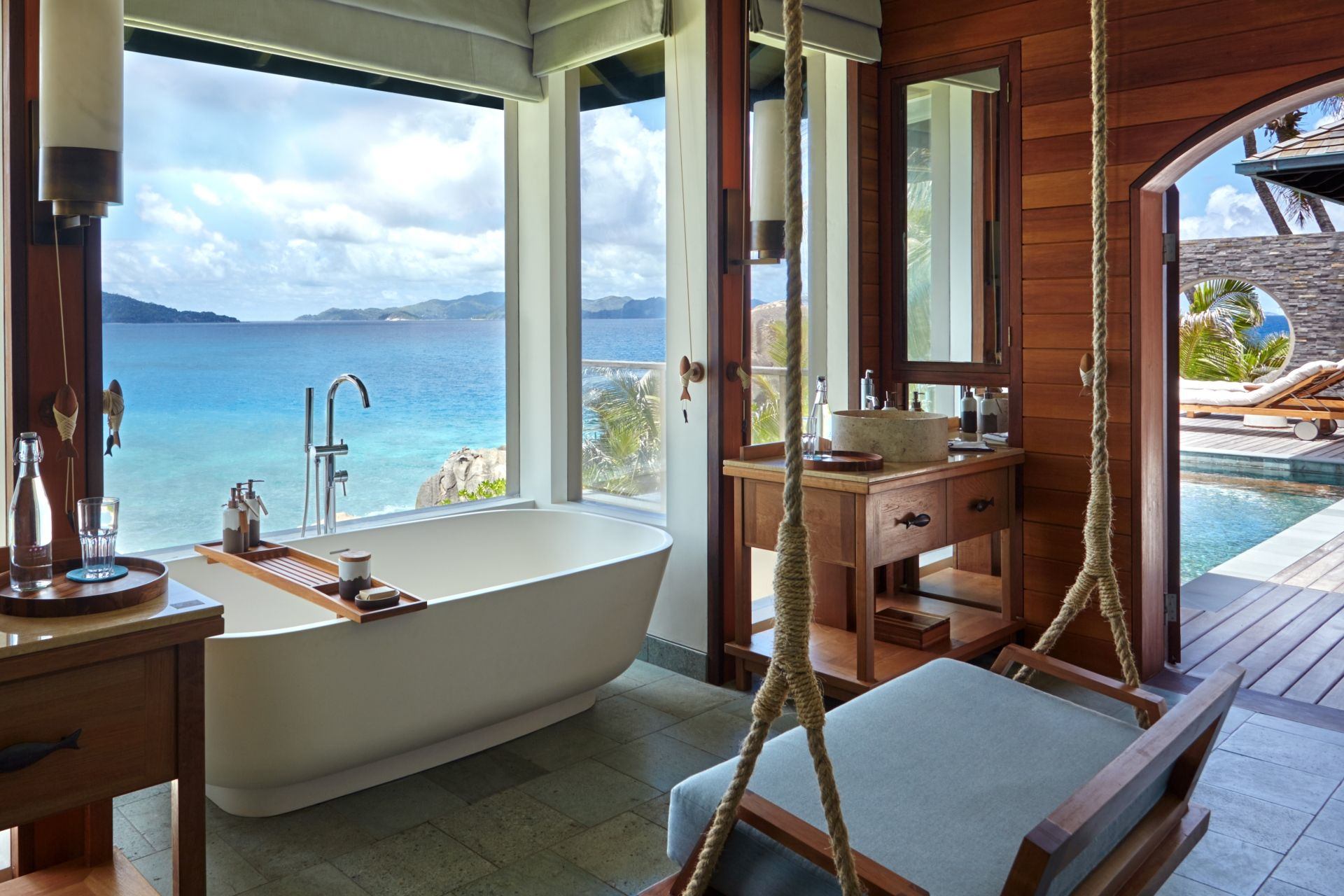 Bathtub in bedroom with with view out across the ocean at six senses zil payson seychelles