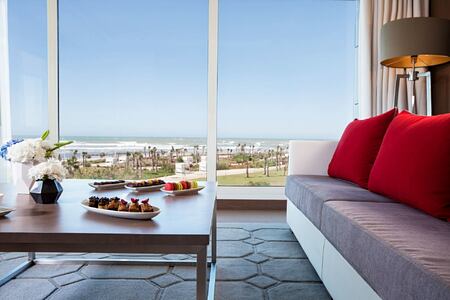 one of the suites a vichy morocco with sofa and view out to the ocean