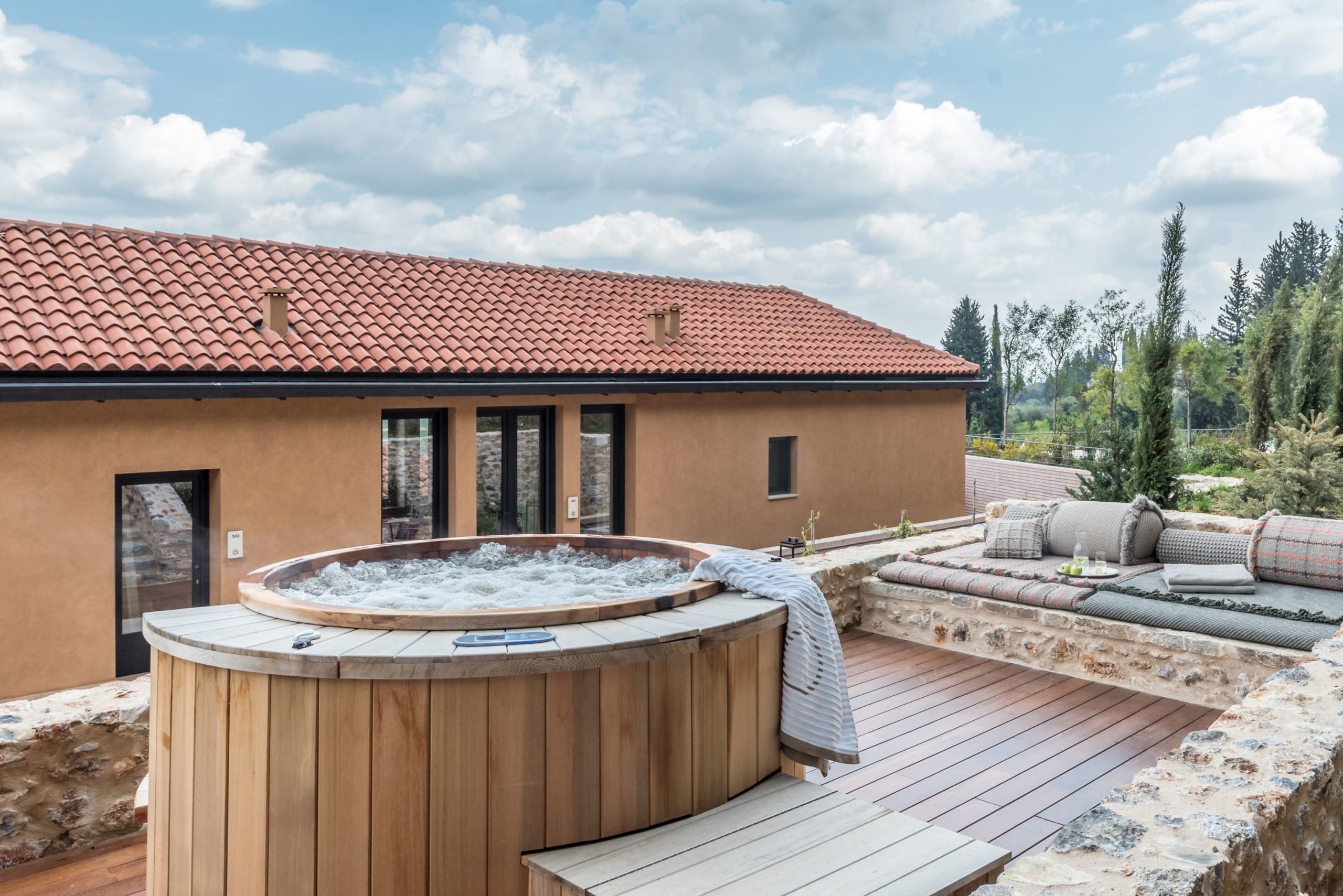 Outdoor hot tub and decked area of a byzantium suite at Euphoria Greece