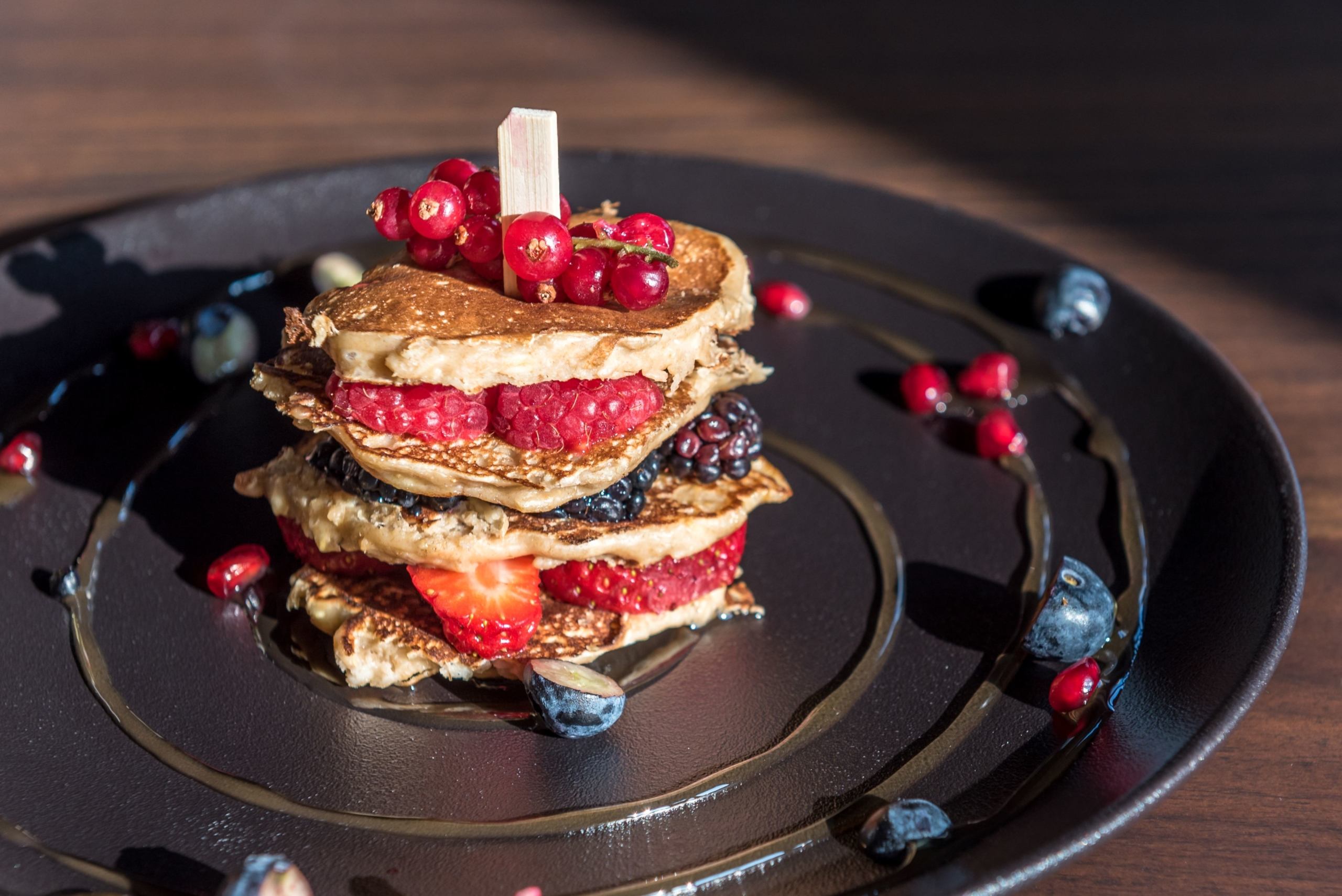 Stack of pancakes with fresh berries and compote at Gaia restaurant
