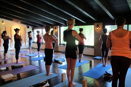 Group yoga class happening in the indoor studio