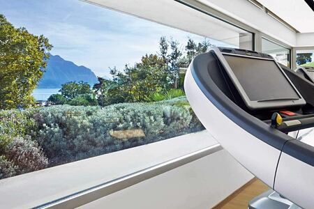 Clinique La Prairie Switzerland Fitness Room with view across lake and mountains