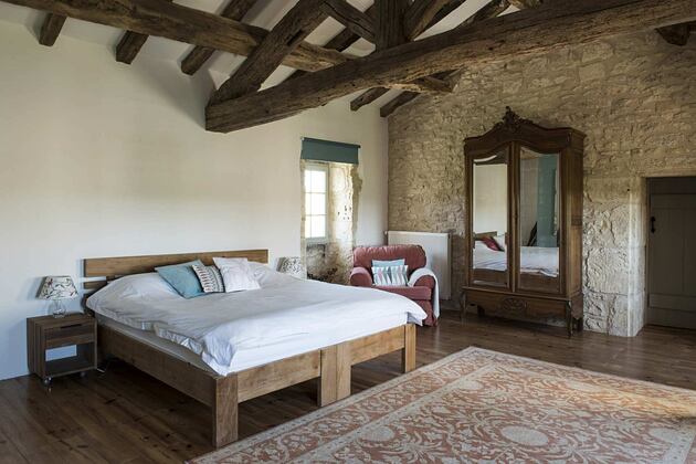 Bedroom with beams at Chateau Puissentut France