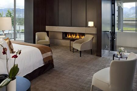 Bedroom with fireplace at Fairmont Pacific Rim Canada
