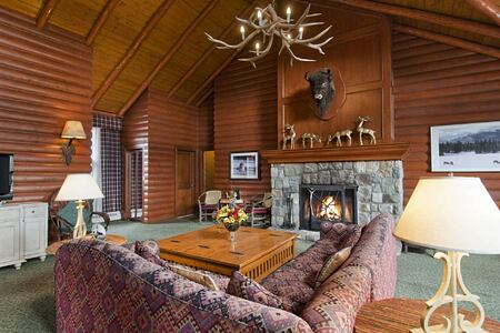 Lounge with fireplace in chalet at Fairmont Jasper Park Lodge Canada