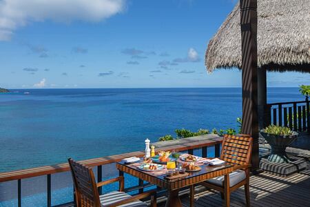 Outdoor dining with sea view at Anantara Maia Seychelles